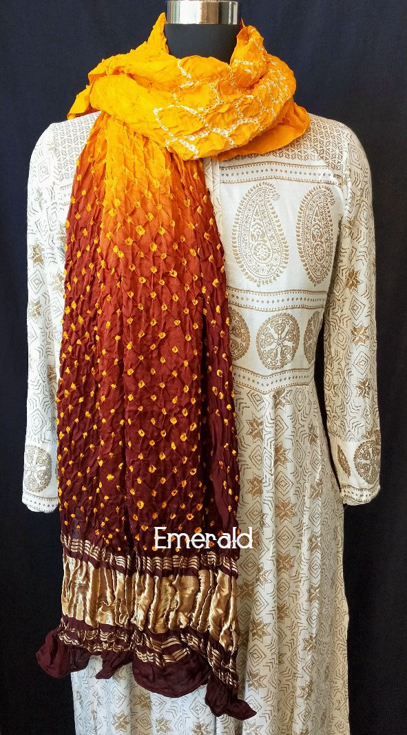 An ancient craft of 5000 years old,the term `Bandhani` is derived from the word `Bandhan' that means tying up, mainly used in the states of Gujarat and Rajasthan.This one is a shaded yellow and maroon Bandhani on pure gajji silk with gold tissue patta at both ends. A total must-have for your festive/ wedding wardrobe.