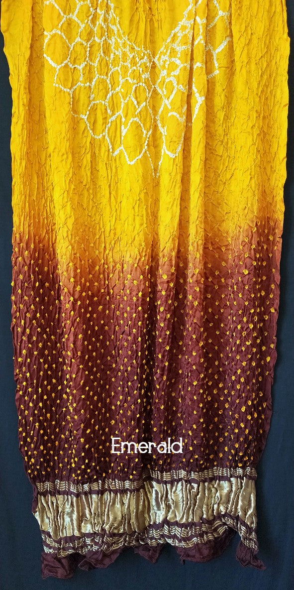 An ancient craft of 5000 years old,the term `Bandhani` is derived from the word `Bandhan' that means tying up, mainly used in the states of Gujarat and Rajasthan.This one is a shaded yellow and maroon Bandhani on pure gajji silk with gold tissue patta at both ends. A total must-have for your festive/ wedding wardrobe.