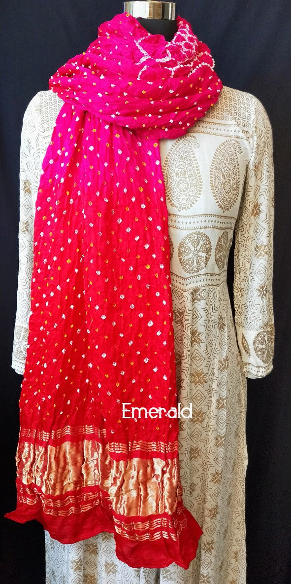 An ancient craft of 5000 years old, the term `Bandhani` is derived from the word `Bandhan' that means tying up, mainly used in the states of Gujarat and Rajasthan. This one is a shaded pink and red Bandhani on pure gajji silk with gold tissue patta at both ends. A total must-have for your festive/ wedding wardrobe.