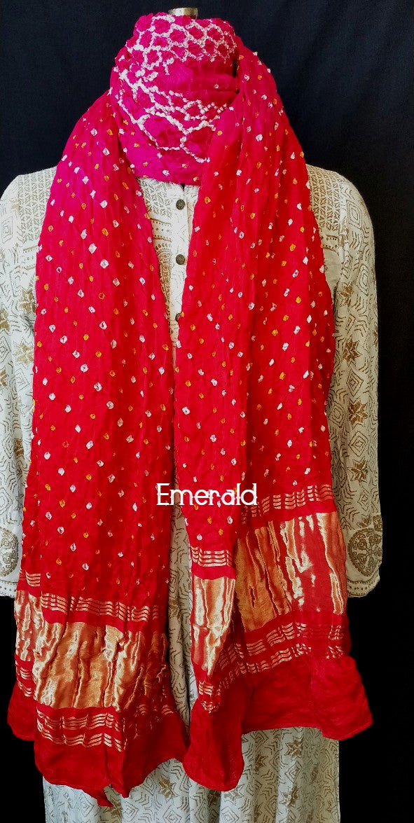 An ancient craft of 5000 years old, the term `Bandhani` is derived from the word `Bandhan' that means tying up, mainly used in the states of Gujarat and Rajasthan. This one is a shaded pink and red Bandhani on pure gajji silk with gold tissue patta at both ends. A total must-have for your festive/ wedding wardrobe.