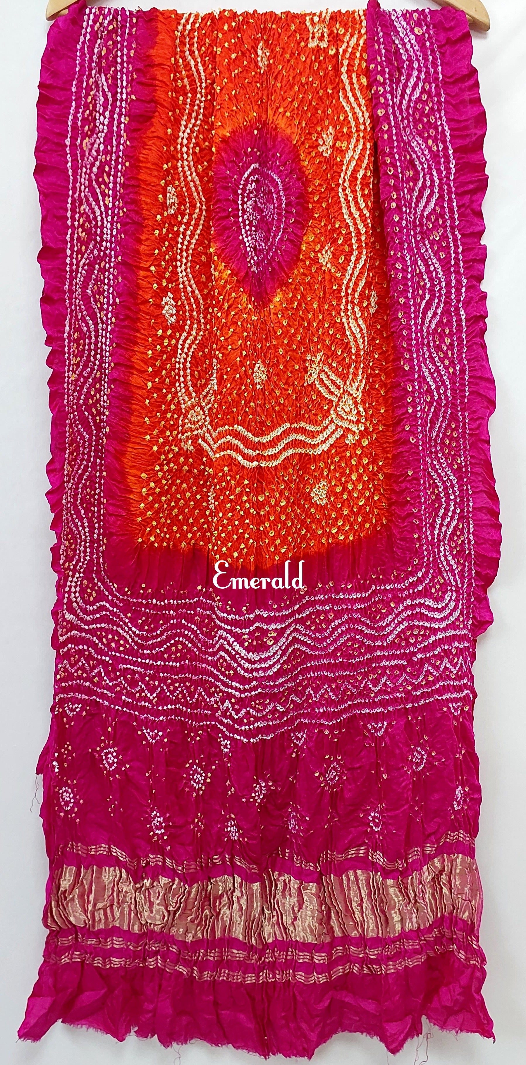 An ancient craft of 5000 years old, the term `Bandhani` is derived from the word `Bandhan' that means tying up, mainly used in the states of Gujarat and Rajasthan. This one is a shaded pink and orange Bandhani on pure gajji silk with gold tissue patta at both ends. A total must-have for your festive/ wedding wardrobe.