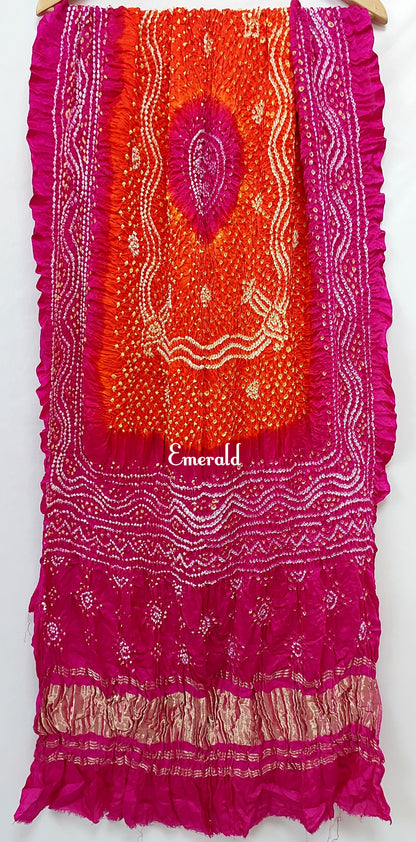 An ancient craft of 5000 years old, the term `Bandhani` is derived from the word `Bandhan' that means tying up, mainly used in the states of Gujarat and Rajasthan. This one is a shaded pink and orange Bandhani on pure gajji silk with gold tissue patta at both ends. A total must-have for your festive/ wedding wardrobe.