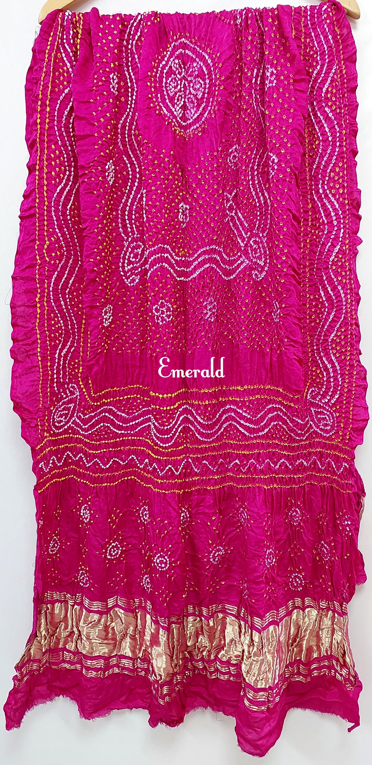 An ancient craft of 5000 years old, the term `Bandhani` is derived from the word `Bandhan' that means tying up, mainly used in the states of Gujarat and Rajasthan. This one is a pink Bandhani on pure gajji silk with gold tissue patta at both ends. A total must-have for your festive/ wedding wardrobe. 