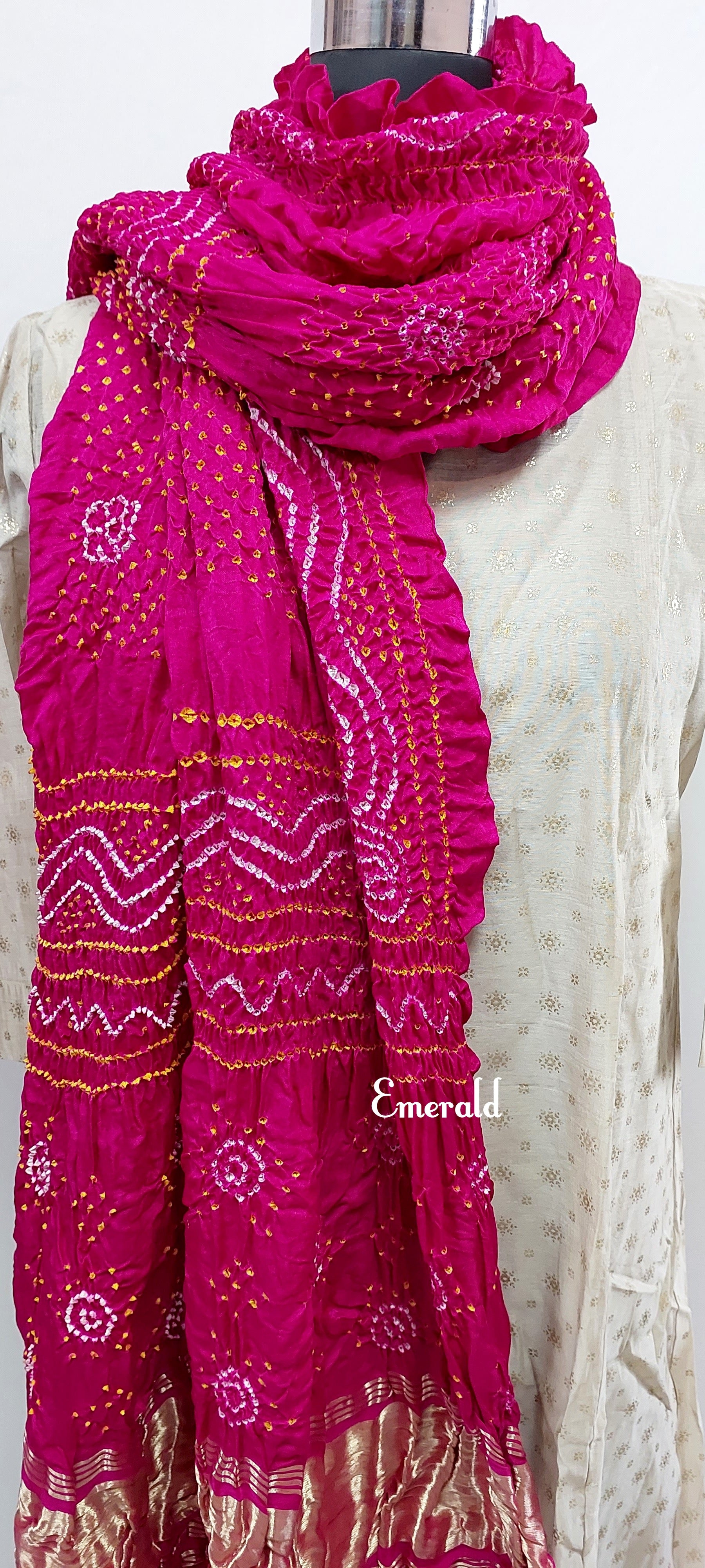 An ancient craft of 5000 years old, the term `Bandhani` is derived from the word `Bandhan' that means tying up, mainly used in the states of Gujarat and Rajasthan. This one is a pink Bandhani on pure gajji silk with gold tissue patta at both ends. A total must-have for your festive/ wedding wardrobe. 