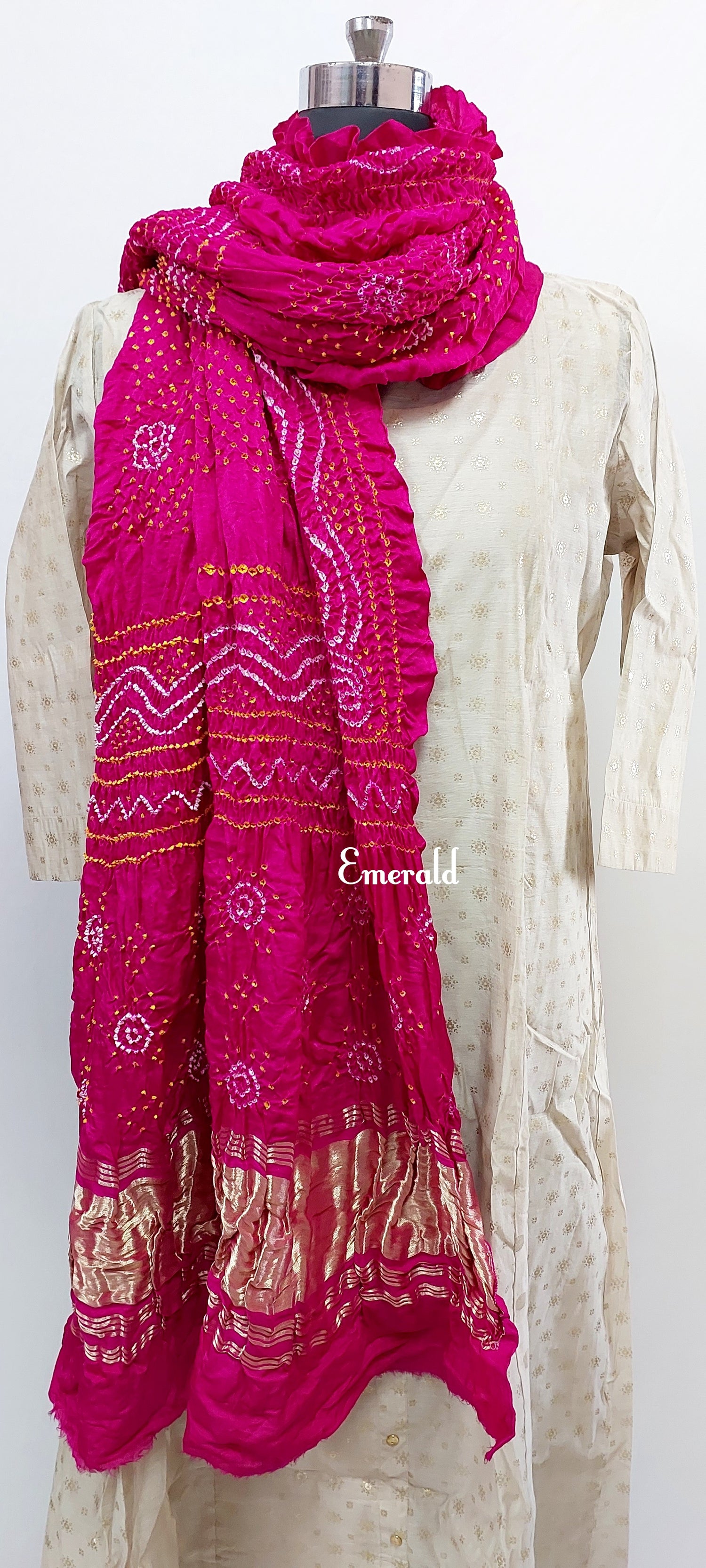 An ancient craft of 5000 years old, the term `Bandhani` is derived from the word `Bandhan' that means tying up, mainly used in the states of Gujarat and Rajasthan. This one is a pink Bandhani on pure gajji silk with gold tissue patta at both ends. A total must-have for your festive/ wedding wardrobe. 