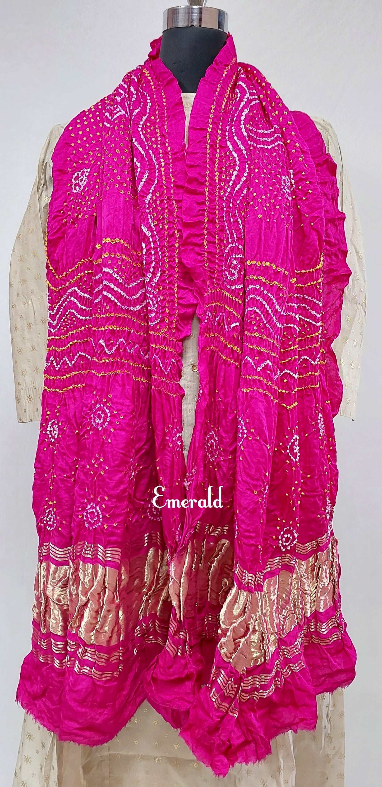 An ancient craft of 5000 years old, the term `Bandhani` is derived from the word `Bandhan' that means tying up, mainly used in the states of Gujarat and Rajasthan. This one is a pink Bandhani on pure gajji silk with gold tissue patta at both ends. A total must-have for your festive/ wedding wardrobe. 