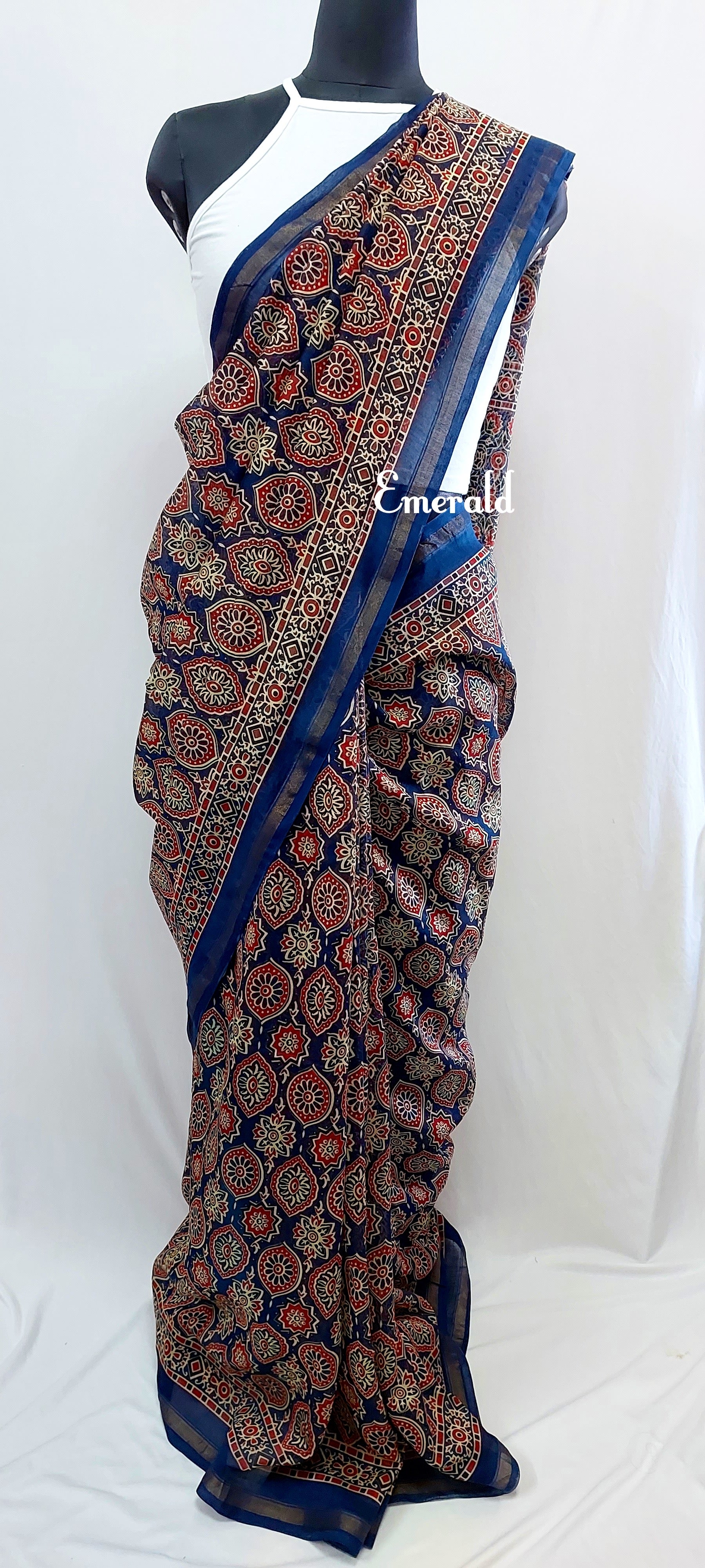 Traditionally, Ajrakh is the name of a block printed cloth with deep crimson red and indigo blue background, bearing symmetrical patterns with interspersed unprinted sparkling white motifs. Here we have a stunning blue screen printed Ajrakh on handwoven Chanderi. Mix and match with our ready to wear blouses for creating unique ensembles.