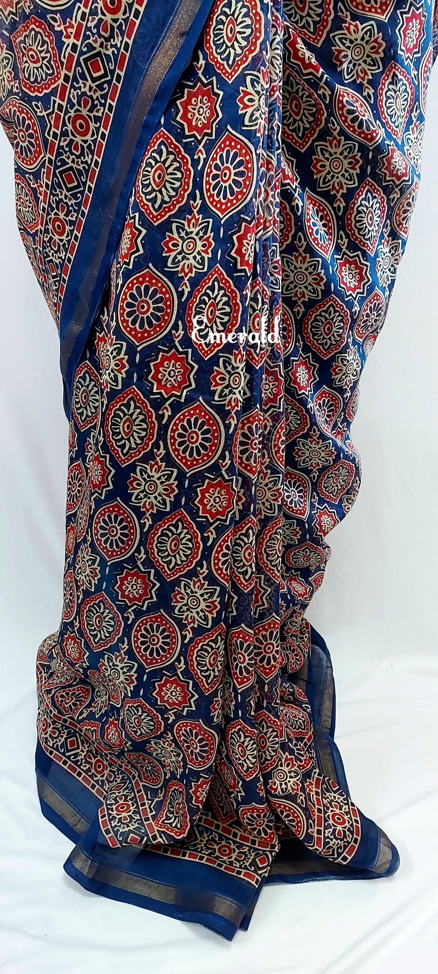 Traditionally, Ajrakh is the name of a block printed cloth with deep crimson red and indigo blue background, bearing symmetrical patterns with interspersed unprinted sparkling white motifs. Here we have a stunning blue screen printed Ajrakh on handwoven Chanderi. Mix and match with our ready to wear blouses for creating unique ensembles.