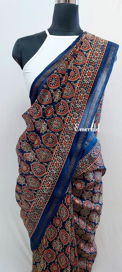 Traditionally, Ajrakh is the name of a block printed cloth with deep crimson red and indigo blue background, bearing symmetrical patterns with interspersed unprinted sparkling white motifs. Here we have a stunning blue screen printed Ajrakh on handwoven Chanderi. Mix and match with our ready to wear blouses for creating unique ensembles.