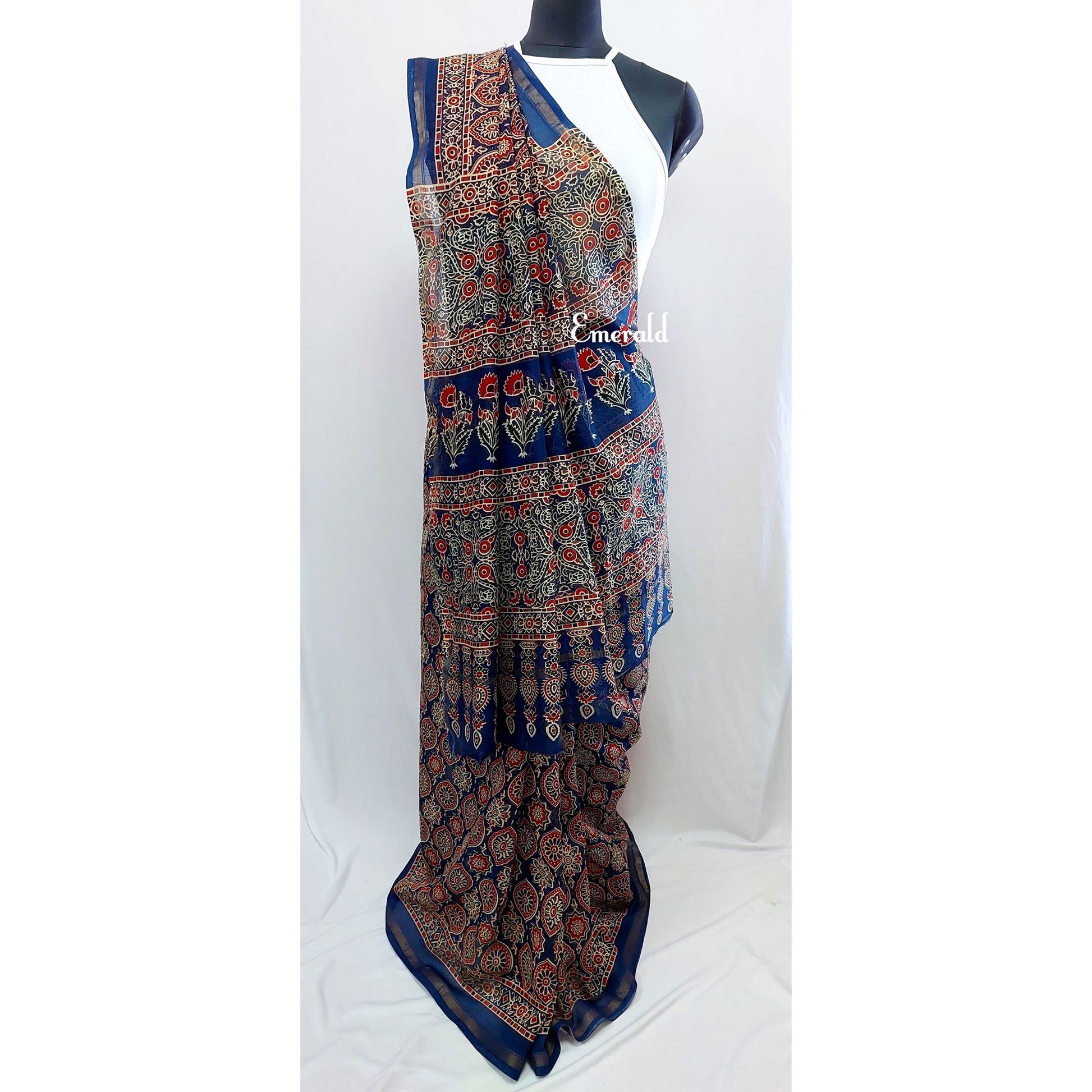 Traditionally, Ajrakh is the name of a block printed cloth with deep crimson red and indigo blue background, bearing symmetrical patterns with interspersed unprinted sparkling white motifs. Here we have a stunning blue screen printed Ajrakh on handwoven Chanderi. Mix and match with our ready to wear blouses for creating unique ensembles.