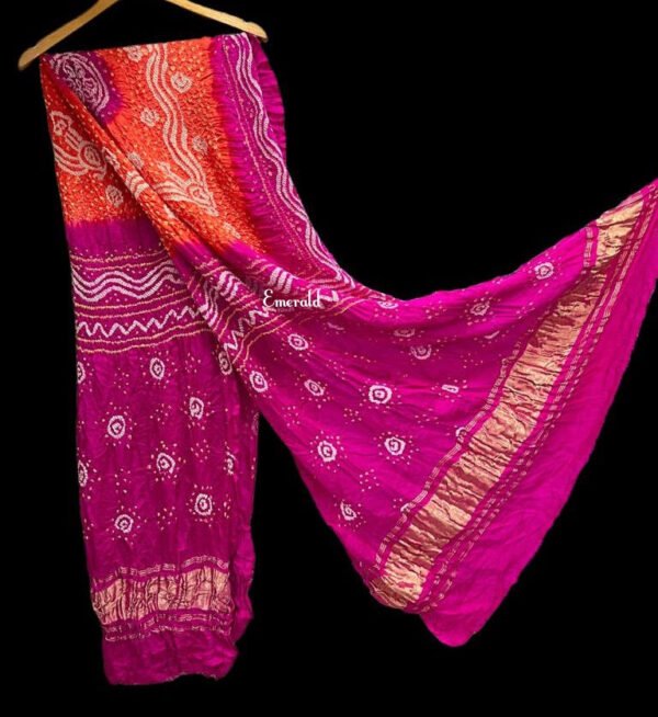 An ancient craft of 5000 years old, the term `Bandhani` is derived from the word `Bandhan' that means tying up, mainly used in the states of Gujarat and Rajasthan. This one is a shaded pink and orange Bandhani on pure gajji silk with gold tissue patta at both ends. A total must-have for your festive/ wedding wardrobe.