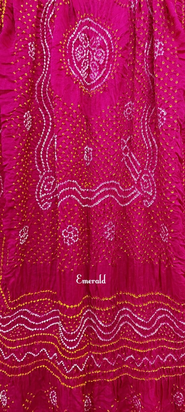 An ancient craft of 5000 years old, the term `Bandhani` is derived from the word `Bandhan' that means tying up, mainly used in the states of Gujarat and Rajasthan. This one is a pink Bandhani on pure gajji silk with gold tissue patta at both ends. A total must-have for your festive/ wedding wardrobe.