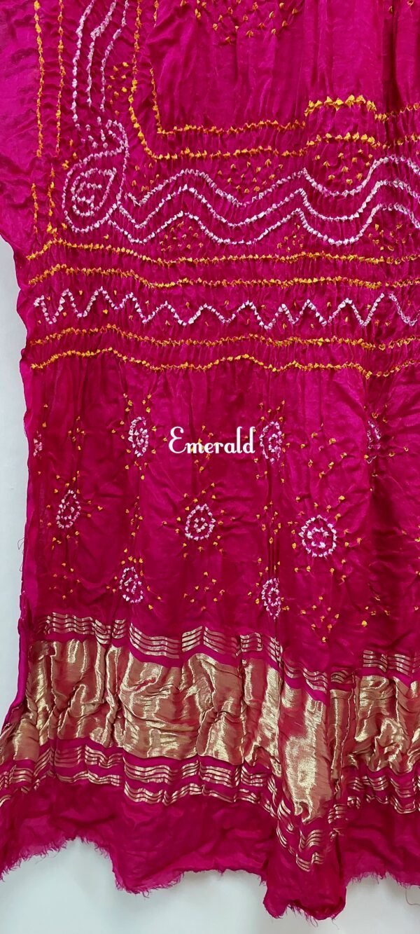 An ancient craft of 5000 years old, the term `Bandhani` is derived from the word `Bandhan' that means tying up, mainly used in the states of Gujarat and Rajasthan. This one is a pink Bandhani on pure gajji silk with gold tissue patta at both ends. A total must-have for your festive/ wedding wardrobe.