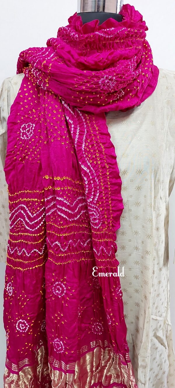 An ancient craft of 5000 years old, the term `Bandhani` is derived from the word `Bandhan' that means tying up, mainly used in the states of Gujarat and Rajasthan. This one is a pink Bandhani on pure gajji silk with gold tissue patta at both ends. A total must-have for your festive/ wedding wardrobe.